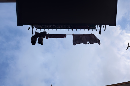 Balcony  with clothes hanging on a clothesline with the sky as background