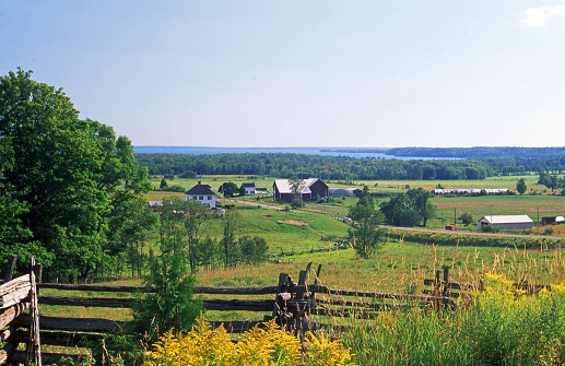 Rural scenes and split rail fences dot the small island.  Lake Huron is seen off in the distance.