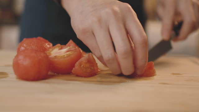 hand deseeding and chopping tomatoes
