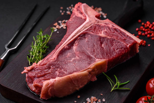 istock Raw juicy beef t-bone steak with salt, spices and herbs 1502551514