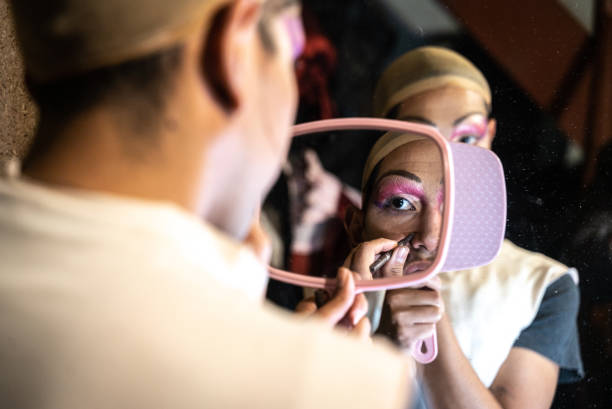 Drag queen doing makeup backstage at the theater