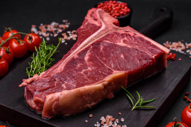 istock Raw juicy beef t-bone steak with salt, spices and herbs 1502552378