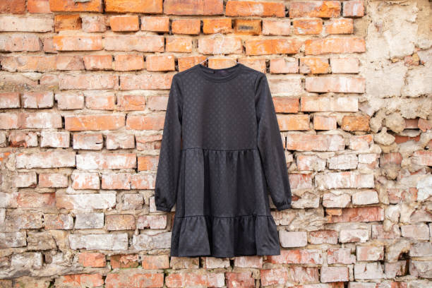 istock black womens dress hanging on a brick old wall outside 1502553543