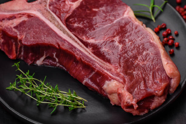 istock Raw juicy beef t-bone steak with salt, spices and herbs 1502553853