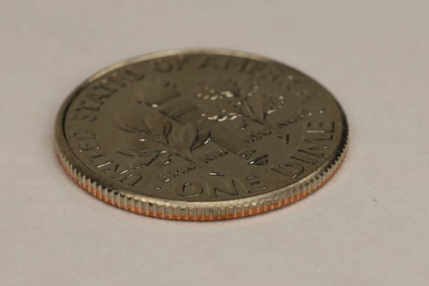 1940 silver Mercury dime close-up on black background.