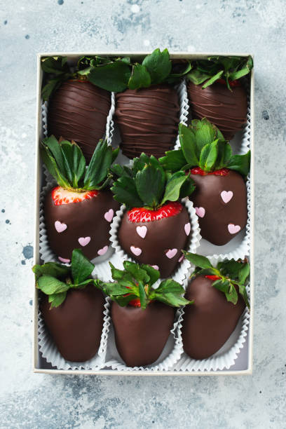 istock Gourmet chocolate covered strawberries on the light background. 1502558961