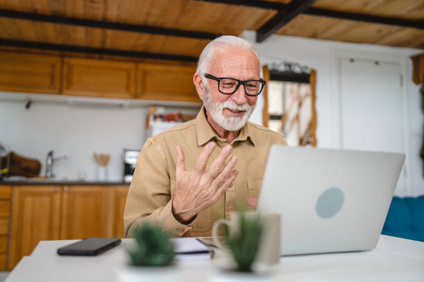 istock Senior caucasian man use laptop computer to make a video call at home 1502560768