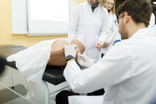 istock Professor aiding medical students in practical gynecology class 1502562610