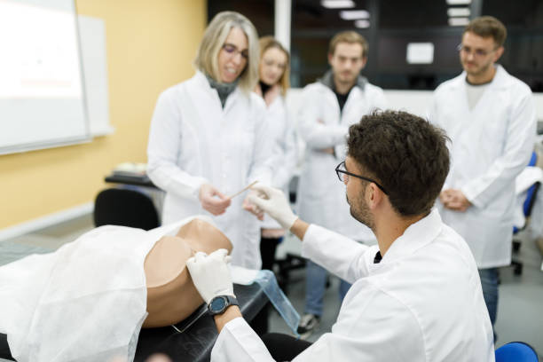 istock Professor aiding medical students in practical gynecology class 1502562724