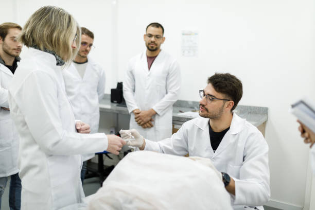 istock Professor aiding medical students in practical gynecology class 1502562754