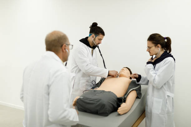 istock Professor aiding medical students on how to use a stethoscope 1502562954