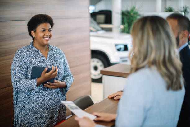 istock mid age couple in the car showroom 1502568788