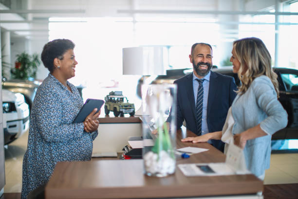 istock mid age couple visiting the car showroom 1502572123
