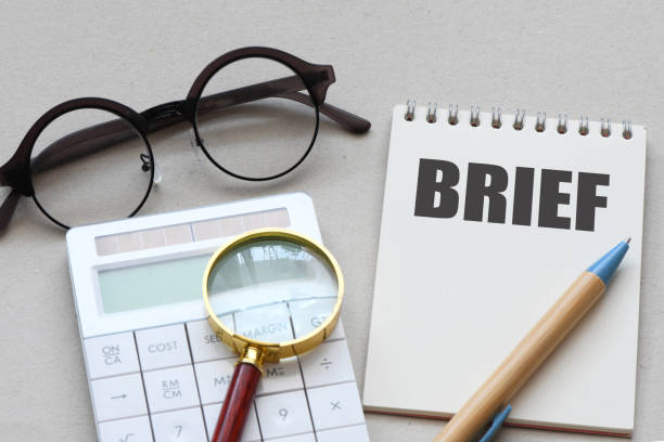 istock Concept Brief on notebook with glasses and pencil 1502572163