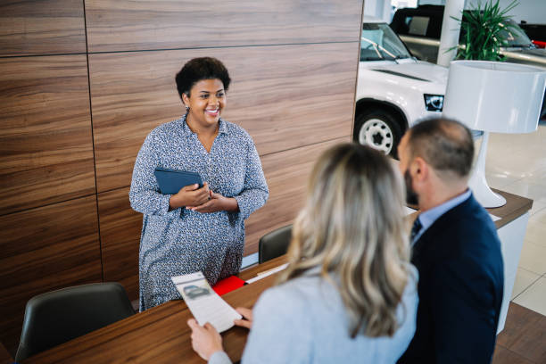istock mid age couple in the car showroom 1502573193