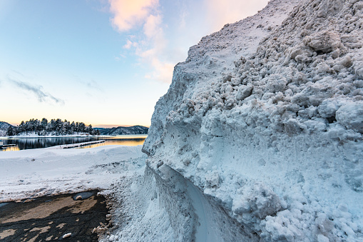 Snow wall on the roadside in an alpine scenery