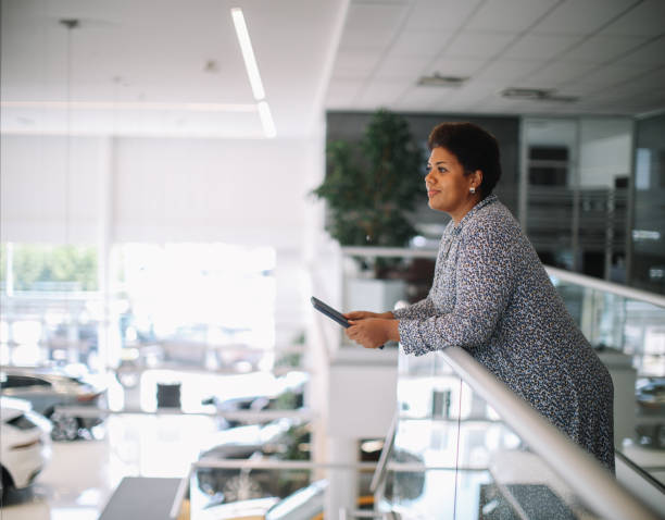 salesperson in the car showroom stock photo