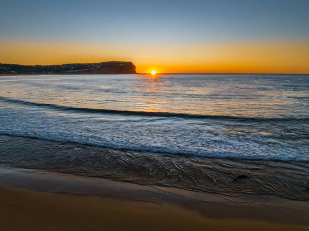 istock Clear skies and flat surf sunrise seascape 1502579937