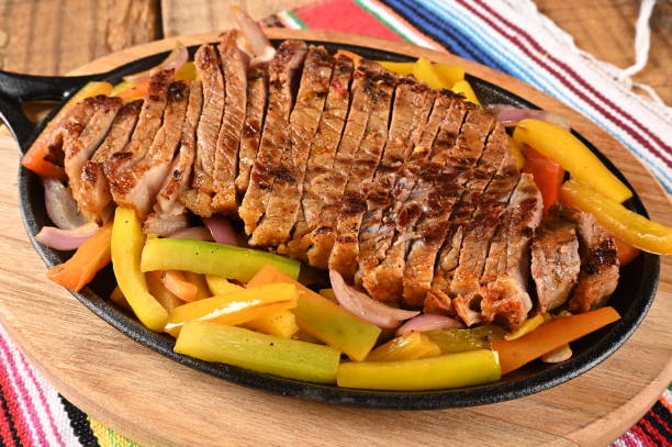 istock roasted meat with vegetables, barbecue with herb sauces, grilled steak.. 1502585061