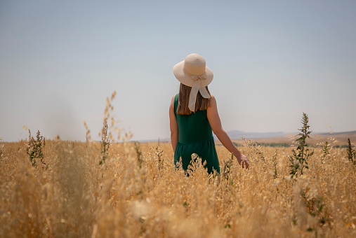 Young beautiful blonde woman in a field of sunflowers