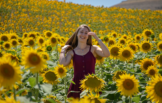 Young beautiful blonde woman in a field of sunflowers