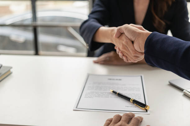 istock Job interview. Two businessmen shake hands to submit resume documents. HR manager shakes hands congratulating job candidates for successful job application close up pictures 1502629601