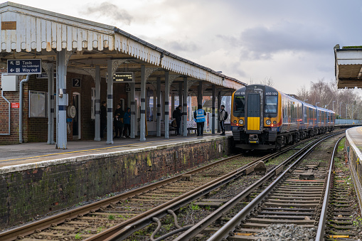 Farnham, England - January 17, 2020: Train Station in Farnham, England. South Western Railway Train to London Waterloo station. People Are Waiting for Departure