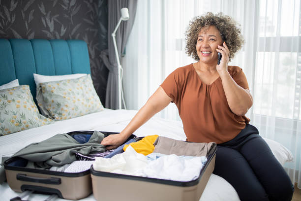 istock Happy mature woman is getting ready for her annual vacation and trip 1502634310