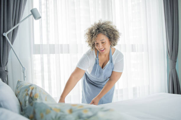 istock Housekeeper is making the bed in the hotel 1502638494