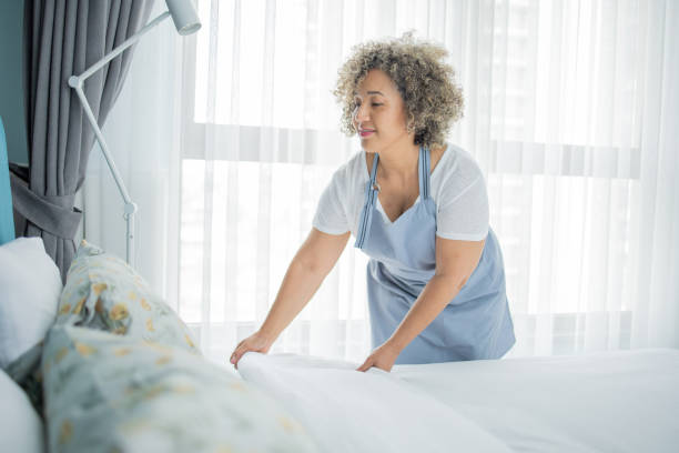 istock Housekeeper is making the bed in the hotel 1502638499