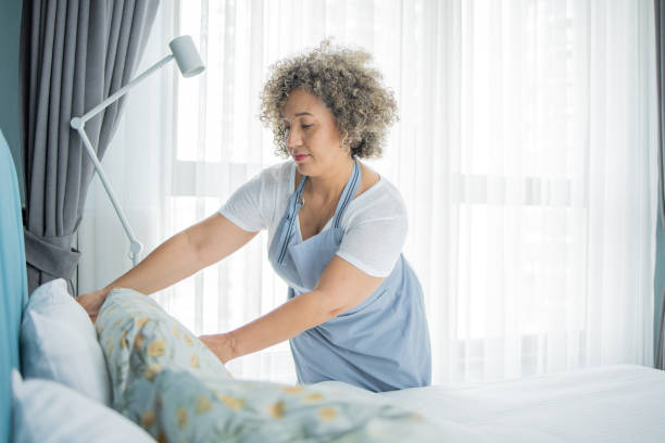 istock Housekeeper is making the bed in the hotel 1502638502