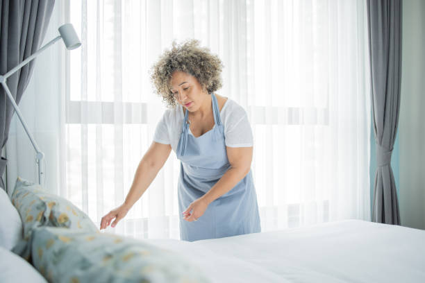 istock Housekeeper is making the bed in the hotel 1502638504