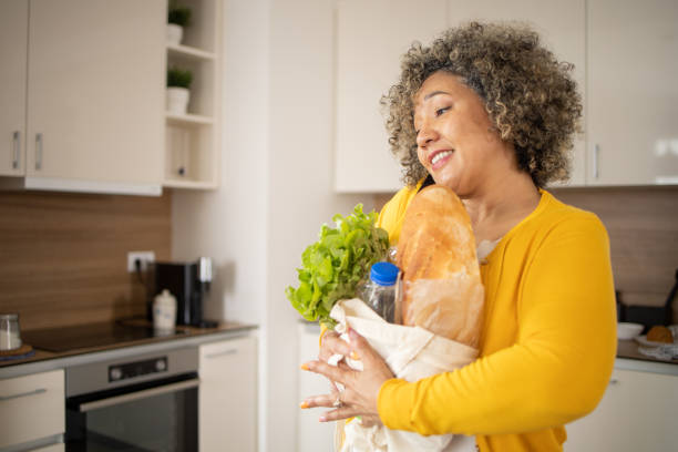 istock Young woman is returning from grocery shopping 1502646984