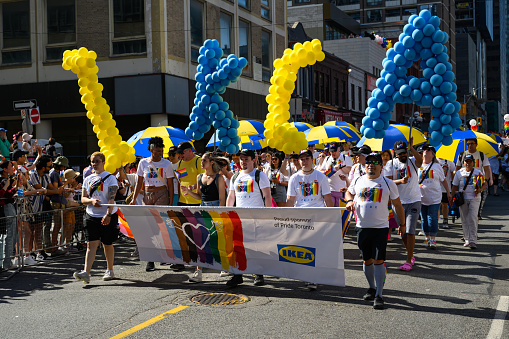 Toronto, Canada - June 25, 2023: IKEA team celebrates at the Pride Toronto Parade , organized by Pride Toronto, a non-profit organization.