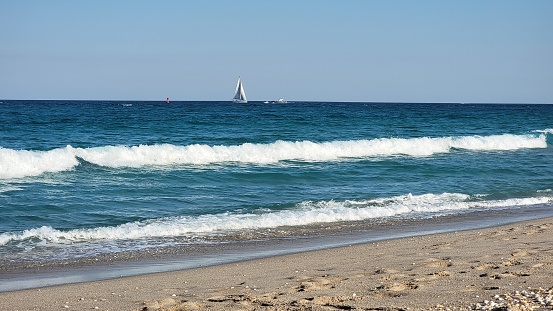 Sailboat beyond the waves