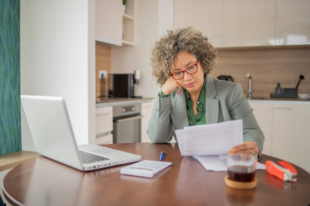 istock Mature woman going through paperwork 1502654235