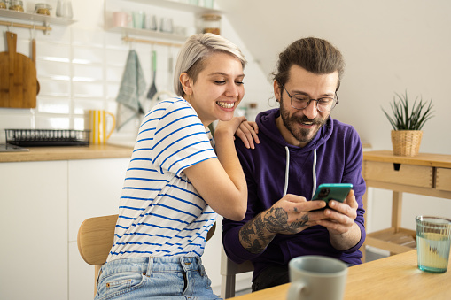 Young couple enjoying together and using smartphone