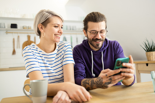 Young couple enjoying together and using smartphone