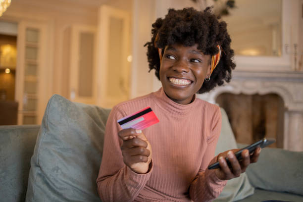 istock Cheerful  woman doing online shopping 1502674237