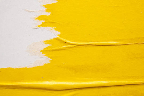 istock Old grunge ripped torn yellow paper poster surface texture background 1502674350