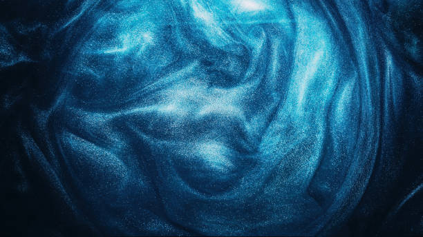 istock Glitter liquid paint water shiny swirl blue smoke 1502674446