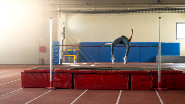 istock Sportswoman high jumping through pole 1502674625