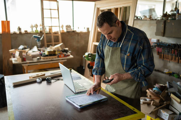 istock Carpenter working in his workshop.Small business owner. 1502677393