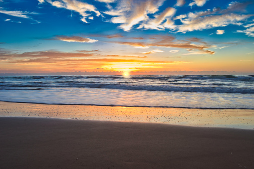 The sun rises over the Gulf of Mexico from South Padre Island beach in Texas.