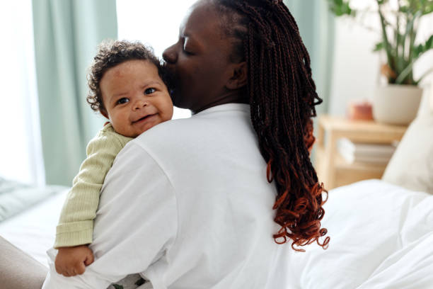 istock Mother kissing her smiling baby boy 1502685836
