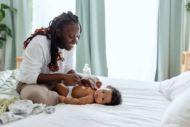 istock Mother putting a body cream on her baby 1502686848