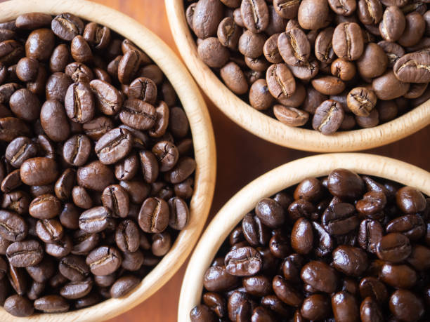 istock brown arabica coffee bean roast 3 level medium to dark different taste seed caffeine espresso drink food cafe beverage Chiang Rai, Thailand coffee on wooden table background top view selected focus 1502700237