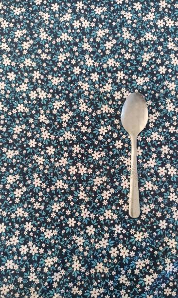 istock stainless spoons on a table clothed with a beautiful floral pattern 1502703484