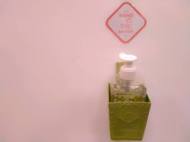 The hand sanitizer bottle is attached to the wall