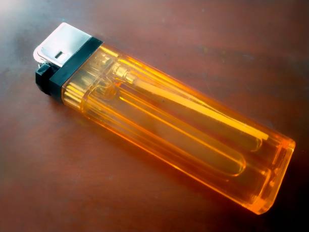 istock Yellow gas lighter on a dark background 1502709211